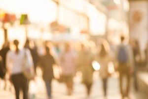 An out of focus picture of people walking on a downtown street. The point is our visual appearance should not matter in determining how to treat one another.